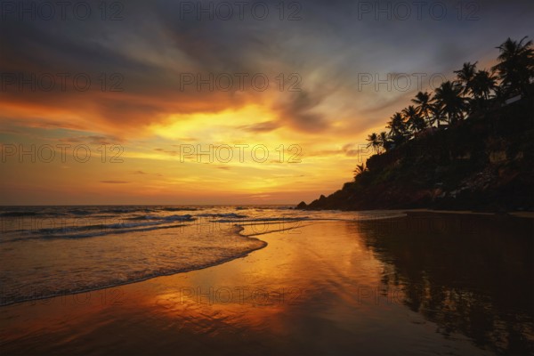 Sunset on Varkala beach popular tourist destination in Kerala state, South India