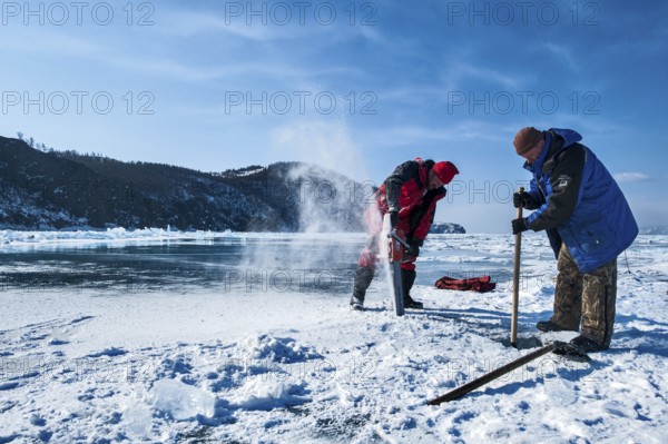 Digging a hole in the ice for scuba diving, Lake Baikal, Olkhon Island, Pribaikalsky National Park, Irkutsk Province, Siberia, Russia, Europe