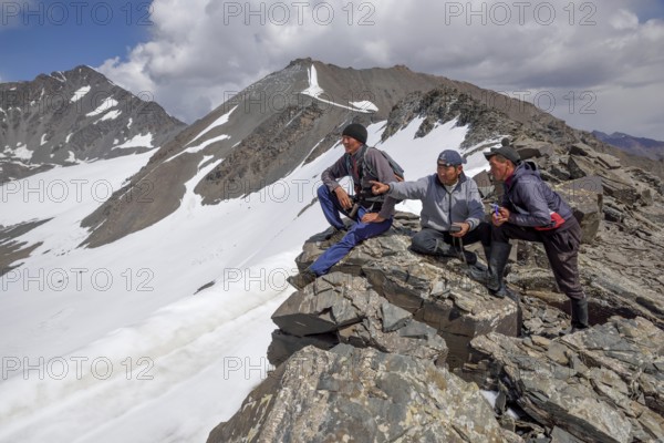 Local hikers on a ridge above the West Karakol Valley, Tian Shan Mountains, Naryn region, Kyrgyzstan, Asia