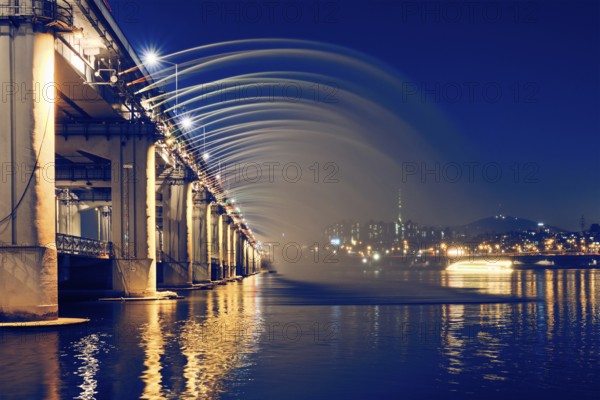 SEOUL, SOUTH KOREA, APRIL 7, 2017: Banpo Bridge Rainbow Fountain on Han river illuminated at night, Seoul, South Korea, Asia