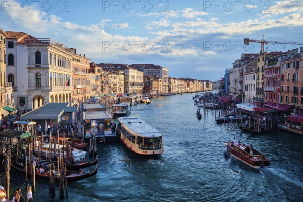 VENICE, ITALY, JUNE 27, 2018: Grand Canal with boats, vaporetto and gondolas on sunset from Rialto bridge, Venice, Italy, Europe