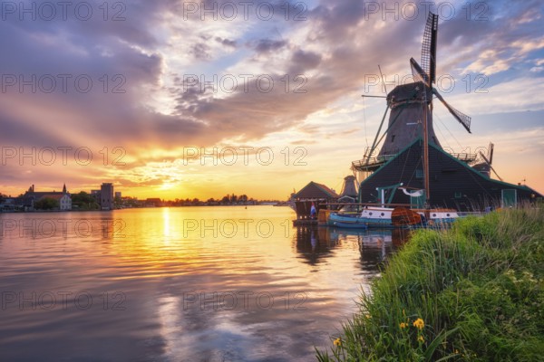 Netherlands rural scene, - windmills at famous tourist site Zaanse Schans in Holland on sunset with dramatic sky. Zaandam, Netherlands