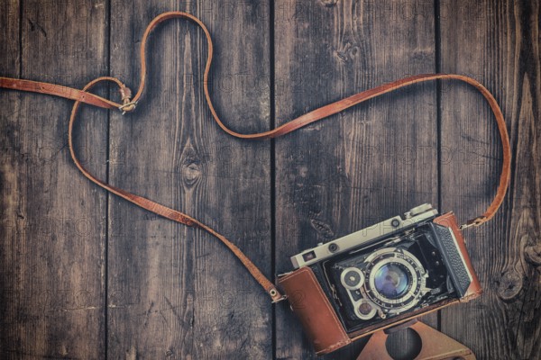 Photography concept background, old retro vintage camera on grunge wooden texture