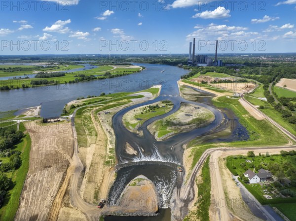 Dinslaken, Voerde, North Rhine-Westphalia, Germany, Renaturalisation of the Emscher. New Emscher estuary into the Rhine. Flood protection through land expansion. The decommissioned STEAG coal-fired power station in Voerde in the background. The mouth of the Emscher into the Rhine was moved from Dinslaken to Voerde, almost 500 metres to the north. Fish can now swim barrier-free up the new Emscher from the Rhine through a newly created floodplain area. Following the construction of a parallel sewer, the Emscher has been completely free of sewage since January 2022. The river was previously an open, above-ground combined sewer with rainwater and wastewater, Europe