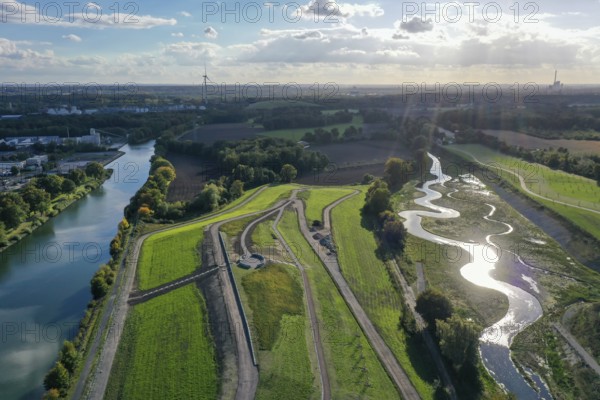 Recklinghausen, Castrop-Rauxel, North Rhine-Westphalia, Germany, Renaturalised Emscher, EMSCHERLAND construction project, a 37-hectare water and nature discovery park at the water crossroads of the Rhine-Herne Canal (left) and the renaturalised Emscher (right) on the city limits of Recklinghausen and Castrop-Rauxel. The ecological focal point at the confluence of Suderwicher Bach and Emscher will also be a future garden for the International Garden Exhibition 2027. Before the renaturalisation, the Emscher river system was an open, above-ground wastewater channel, combined sewer with surface water and wastewater, Europe