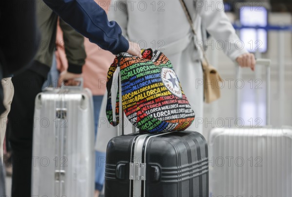 Düsseldorf, North Rhine-Westphalia, Germany - Düsseldorf Airport, Easter holidaymakers at the Condor check-in counter on their way to Majorca during the corona pandemic, hand luggage with Majorca written on it, in front of the flight to Spain and also in front of the return flight to Germany, air travellers must present a negative corona test