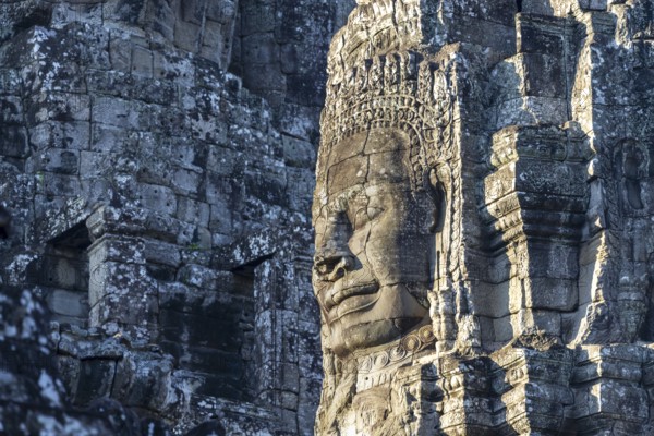 Giant stone-carved face of the Bodhisattva Lokeshvara, also known as Avalokiteshvara, Bayon Temple, Angkor Thom, UNESCO World Heritage Site, Angkor Wat, Siem Reap, Cambodia, Asia