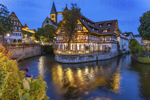 View from the Agnes Bridge to the Roßneckarkanal, half-timbered house with gastronomy and the parish church of St. Dionys at dusk, Esslingen am Neckar, Baden-Württemberg, Germany, Europe
