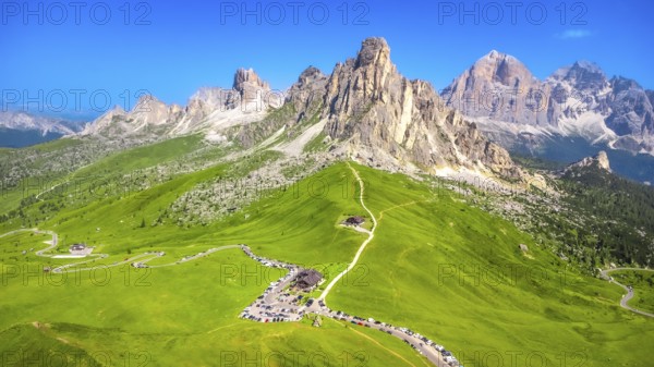 Breathtaking aerial view of the scenic passo giau with its winding road and the majestic nuvolau group in the italian dolomites during a sunny summer day