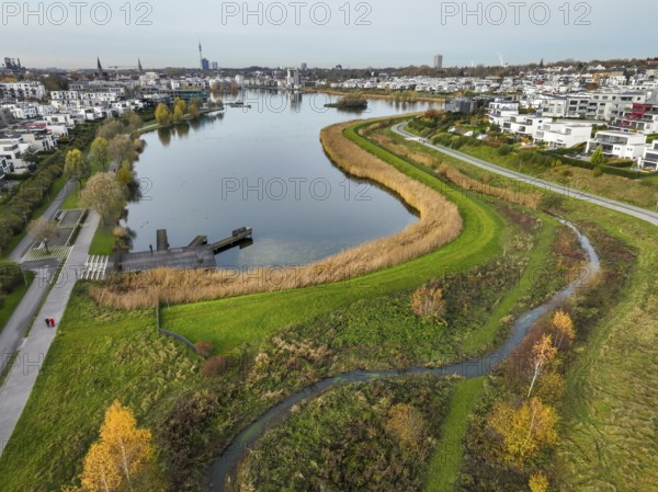 Dortmund, North Rhine-Westphalia, Germany, Phoenix Lake, front of the renaturalised Emscher. The river has been transformed into a near-natural body of water, flood protection and biodiversity through newly designed floodplains. A former industrial wasteland of 99 hectares was transformed into residential, work and leisure areas and 24 hectares of lake surface. In the event of heavy rainfall, the lake acts as a rainwater retention basin. Following the construction of a parallel sewer, the Emscher is now free of wastewater, having previously been an open, above-ground wastewater sewer, combined sewer with surface water and wastewater. The Phoenix Lake, a showcase project for structural change, is an artificial lake on the site of the former Phönix Ost steelworks in Dortmund's Hörde district, Europe