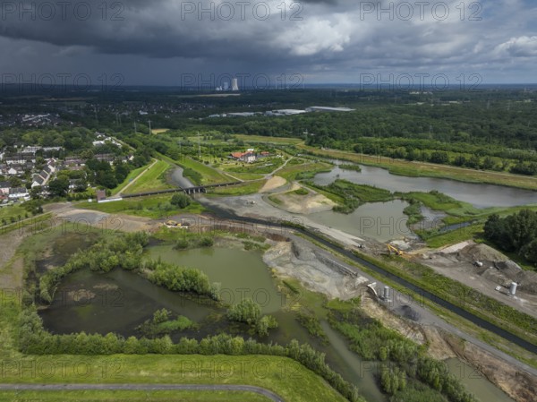 Dortmund / Castrop-Rauxel, North Rhine-Westphalia, Germany, river renaturalisation, renaturation of the Emscher, flood retention basin HRB Mengede. A new floodplain landscape is being created at the Emscher-Auen farm, expanding the area for flood protection during heavy rainfall and for biodiversity. The Emscher, which is currently straightened, will be given curves again and can meander through its new floodplain. Following the construction of a parallel sewer, the Emscher has been completely free of wastewater since 2022. The river was previously an open, above-ground mixed water channel with rainwater and wastewater. The Uniper coal-fired power plant Datteln 4 in the background, Europe