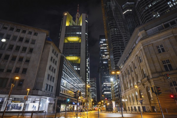 Clouds pass over the shining Commerzbank Tower in the dark evening sky, Rossmarkt, Frankfurt am Main, Hesse, Germany, Europe