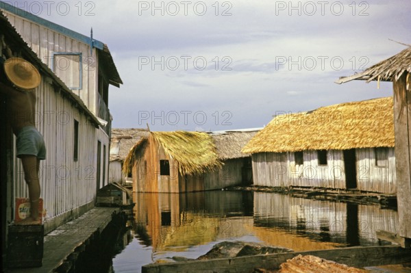 Informal housing built on logs, known as the floating city, Manaus, Brazil 1962, which was removed as part of the slum clearance policy in the late 1960s