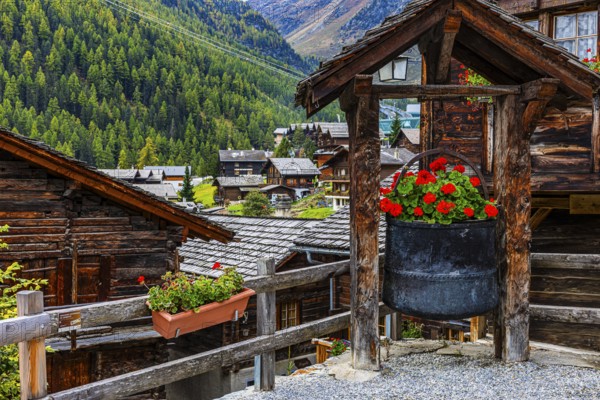 Old copper kettle decorated with flowers in the historic village centre, Grimentz, Val d'Anniviers, Valais Alps, Canton Valais, Switzerland, Europe