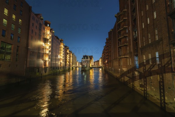 Night shot of a canal with illuminated buildings reflected in the water, Hamburg, Germany, Europe