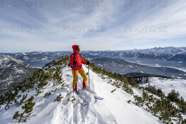 Ski tourer at the summit of Simetsberg, mountain panorama, Estergebirge, Bavarian Prealps, Bavaria Germany