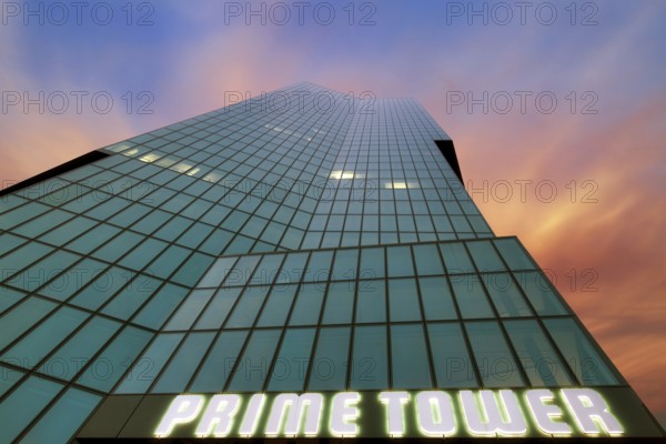 Modern high-rise building Prime Tower with glass facade, coloured clouds in the evening sky after sunset, Zurich West, Canton of Zurich, Switzerland, Europe
