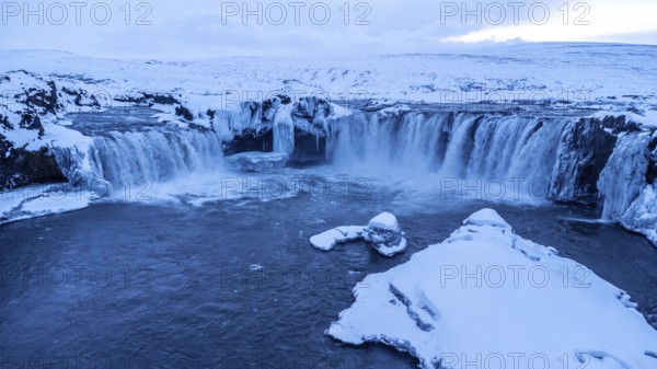 Amazing scenery of frozen Godafoss waterfall at sunset in winter, Iceland, Europe
