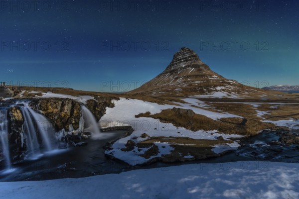 Long exposure on the picturesque Kirkjufell mountain at night in winter in Iceland