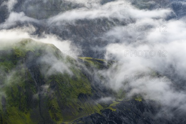 Fog, clouds moving around moss-covered mountains, impressive landscape, Pakgil, Iceland, Europe