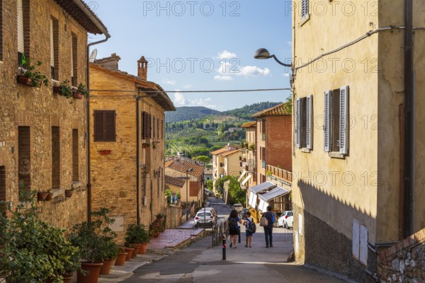 Street with views of the surrounding hills, San Gimignano, Tuscany, Province of Siena, Italy, Europe