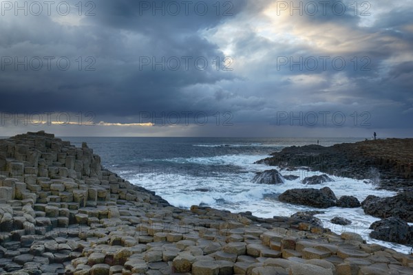 Rocky coast with basalt columns, coastline, dusk, rain clouds, Giant's Causeway, Giants Causeway, Causeway Coastal Route, Antrim, Northern Ireland, Great Britain