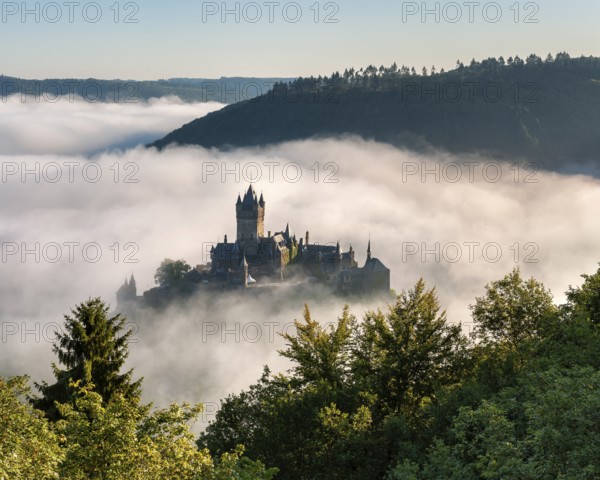 View of the Reichsburg Cochem in autumn, morning mist in the Moselle valley, Cochem, Rhineland-Palatinate, Germany, Europe