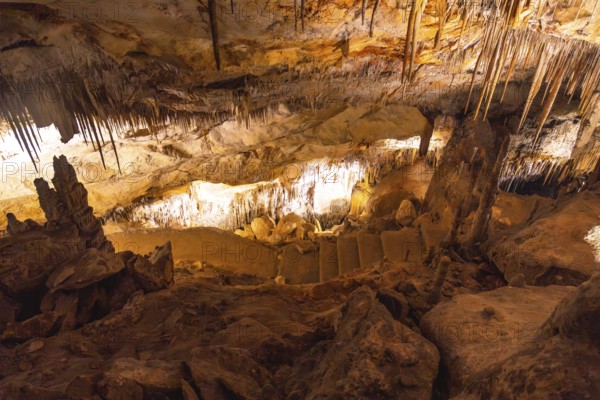 Illuminating stalactites and stalagmites creating a breathtaking spectacle inside the caves of drach in mallorca, spain