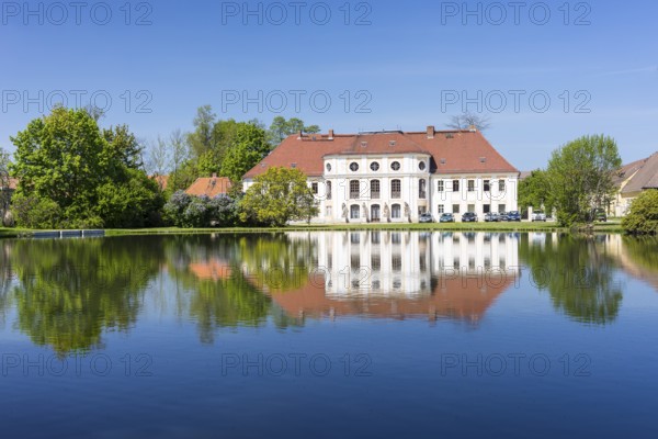 Baroque castle with reflection in the large pond, Königswartha, Upper Lusatia, Saxony, Germany, Europe