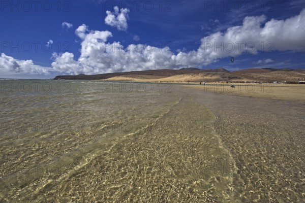 Beach Playa Risco del Paso, Playa de Sotavento with clear water, blue sky and white clouds, mountains in the background, Pajara, Fuerteventura, Canary Islands, Spain, Europe