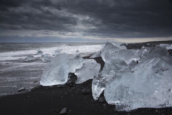 Little icebergs and crushed ice on the black beach at Joekulsarlon glacial lake