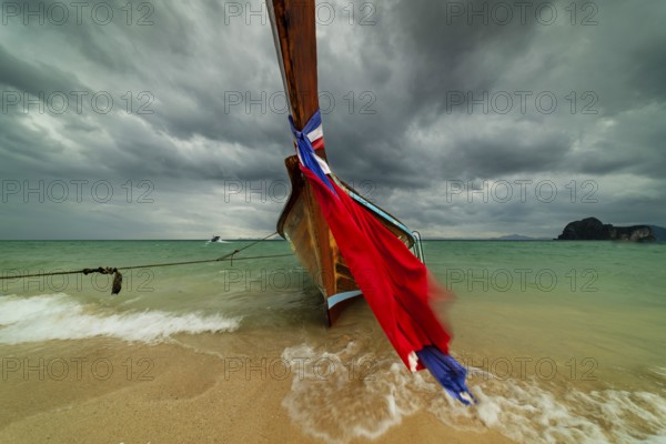 Longtail boat on the beach, dark rain clouds behind, Koh Ngai Island, Andaman Sea, Satun Province, Southern Thailand, Thailand, Asia