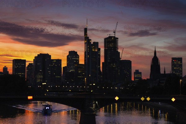 The silhouette of Frankfurt's banking skyline stands out against the luminous evening sky in the evening after sunset., Frankfurt am Main, Hesse, Germany, Europe
