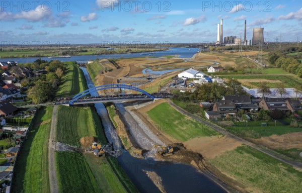 Dinslaken, Voerde, North Rhine-Westphalia, Germany, Inauguration of the new Emscher estuary into the Rhine. The decommissioned STEAG Voerde coal-fired power station is in the background. The mouth of the Emscher into the Rhine has been moved almost 500 metres north from Dinslaken to Voerde. Fish can now swim barrier-free up the new Emscher from the Rhine through a newly created floodplain area. Following the construction of a parallel sewer, the Emscher has been completely free of sewage since January 2022. The river was previously an open, above-ground combined sewer with rainwater and wastewater, Europe