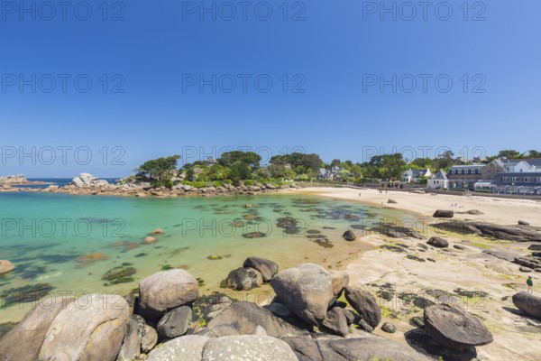 Beach with rocks and sand at the Plage Saint Guirec, with clear blue sky and colors as in the carribians