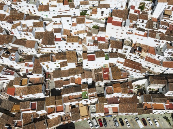 The brilliant White Town of Casares clings to a steep hillside. Aerial view. Drone shot. Málaga province, Andalusia, Spain, Europe