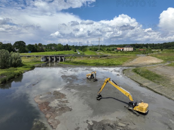 Dortmund / Castrop-Rauxel, North Rhine-Westphalia, Germany, river renaturalisation, renaturation of the Emscher, flood retention basin HRB Mengede. A new floodplain landscape is being created at the Emscher-Auen farm, expanding the area for flood protection during heavy rainfall and for biodiversity. The Emscher, which is currently straightened, will be given curves again and can meander through its new floodplain. Following the construction of a parallel sewer, the Emscher has been completely free of wastewater since 2022. The river was previously an open, above-ground mixed water channel with rainwater and wastewater. At the back right, the Uniper coal-fired power plant Datteln 4 power station, Europe