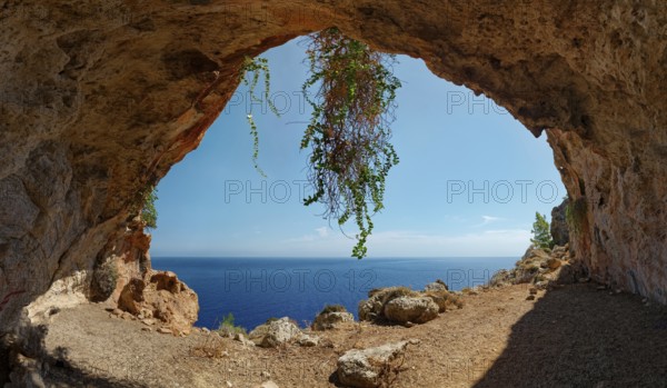 Natural setting of the exit of Limniatis Cave overlooking the sea with rocks and plants, hike from Aperi to Limniatis Cave, Limniatis Cave, Aperi, Karpathos, Greece, Europe