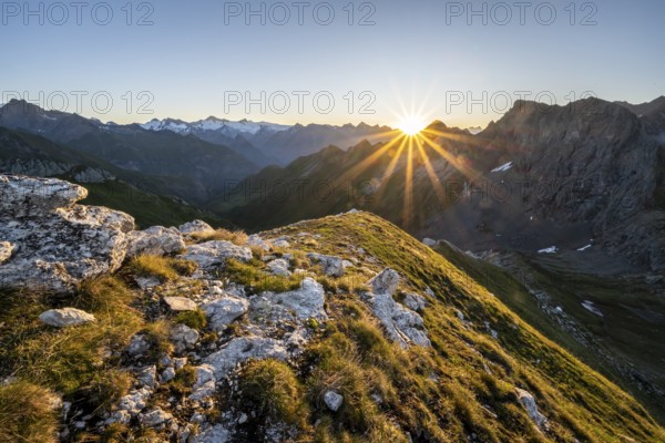 Mountain landscape at sunrise with sun star, view of mountain peaks of the Venediger group and into the Großbachtal valley from the summit of Bachlenkenkopf, Lasörling group, Hohe Tauern National Park, East Tyrol, Tyrol, Austria, Europe