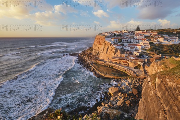 Scenic view of the seaside Azenhas do Mar fishing village on cliff on Atlantic ocean coast, Portugal on sunset