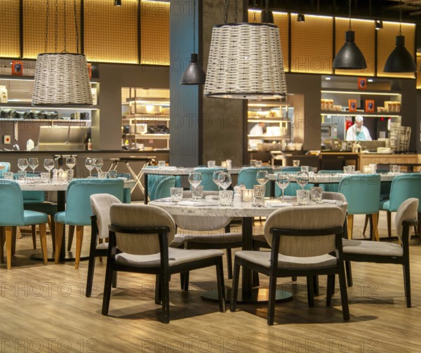 Tables and chairs set for diners in Gino D'acampo restaurant, Melia INNSiDE Liverpool hotel, Liverpool, England, UK