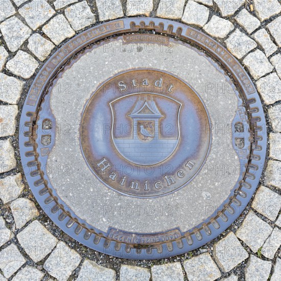 Manhole cover with coat of arms of Hainichen, Saxony, Germany, Europe