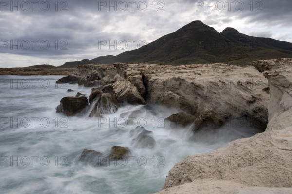 Waves on rocky coast, Playa Los Escullos, Cabo de Gata, Los Escullos, Playa del Arco, El Arco beach, Cabo de Gata-Nijar Natural Park, Almeria, Andalusia, Spain, Europe