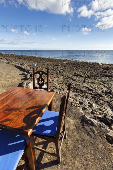 Wooden table and chairs, fish restaurant on the beach, Playa Quemada, Yaiza, Lanzarote, Spain, Europe