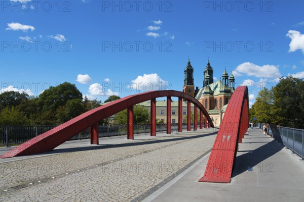 A modern red bridge leads to the cathedral in the background with blue sky and white clouds, Cathedral, Cathedral Basilica of St Peter and Paul the Apostles, Bishop Jordan Bridge, Poznan, Posnan, Poznan, Greater Poland Voivodeship, Poland, Europe