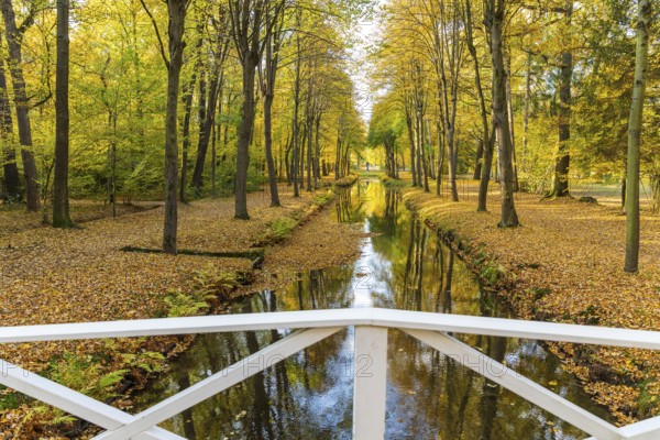 Bridge over the castle moat in autumn, park of Hermsdorf Castle, Ottendorf-Ockrilla, Saxony, Germany, Europe