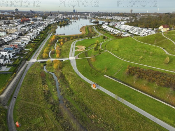Dortmund, North Rhine-Westphalia, Germany, Phoenix Lake, front of the renaturalised Emscher. The river has been transformed into a near-natural body of water, flood protection and biodiversity through newly designed floodplains. A former industrial wasteland of 99 hectares was transformed into residential, work and leisure areas and 24 hectares of lake surface. In the event of heavy rainfall, the lake acts as a rainwater retention basin. Following the construction of a parallel sewer, the Emscher is now free of wastewater, having previously been an open, above-ground wastewater sewer, combined sewer with surface water and wastewater. The Phoenix Lake, a showcase project for structural change, is an artificial lake on the site of the former Phönix Ost steelworks in Dortmund's Hörde district, Europe