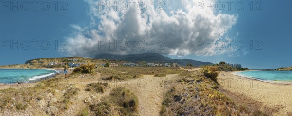 Wide Frangolimiona sandy beach with views of the blue sea, dramatic clouds and a vast coastal landscape, Arkasa, Karpathos, Greece, Europe