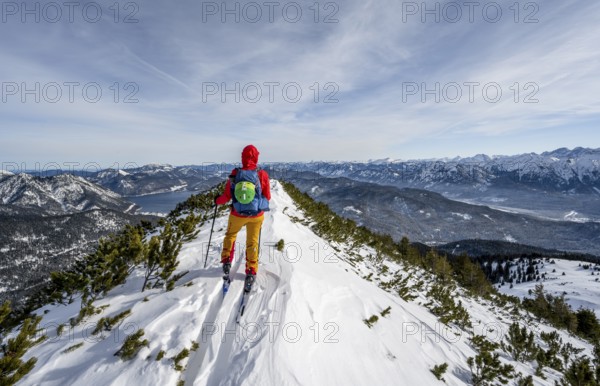 Ski tourer at the summit of Simetsberg, mountain panorama, Estergebirge, Bavarian Prealps, Bavaria Germany