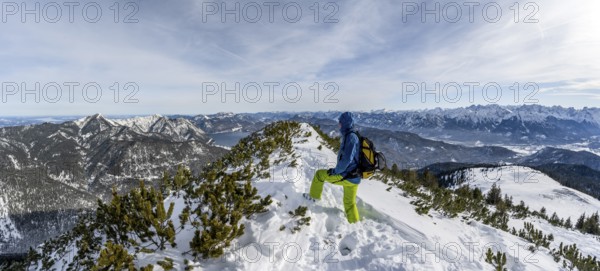 Ski tourer at the summit of Simetsberg, mountain panorama, Estergebirge, Bavarian Prealps, Bavaria Germany